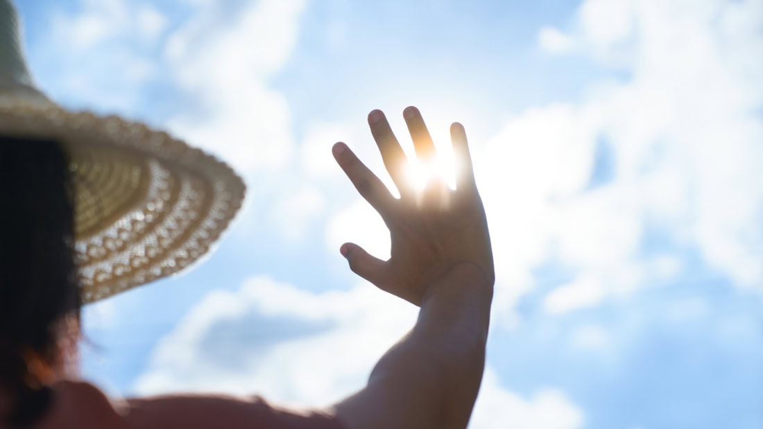 Sunshine and hand covering the sun during heatwave heat plan in the Netherlands.